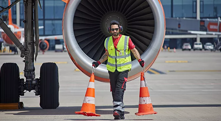 Operario de Swissport colocando conos junto a un avión | Foto: Swissport International Operario de Swissport colocando conos junto a un avión | Foto: Swissport International