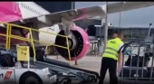 Tripulantes de Wizz Air descargan maletas de una avión